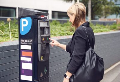 mature-businesswoman-paying-for-car-parking-at-mac-2023-11-27-04-50-36-utc-2